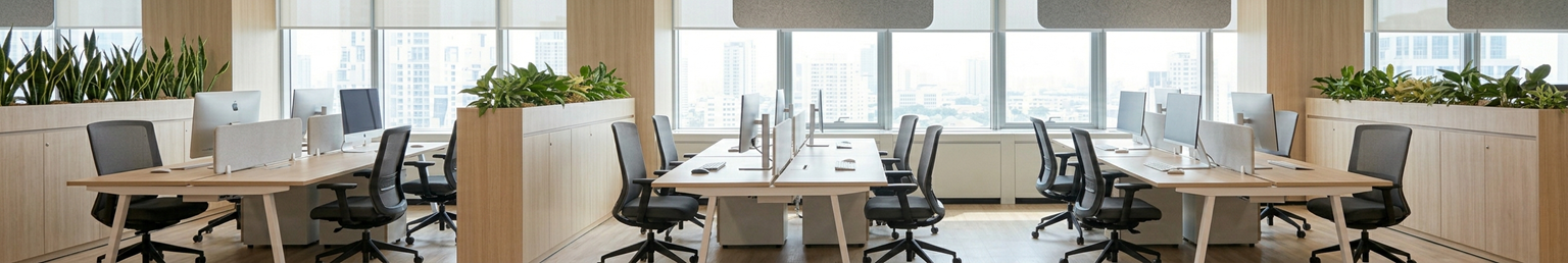 Modern open workstation office featuring collaborative desk clusters, ergonomic chairs, mobile pedestals, and contemporary workspace furniture