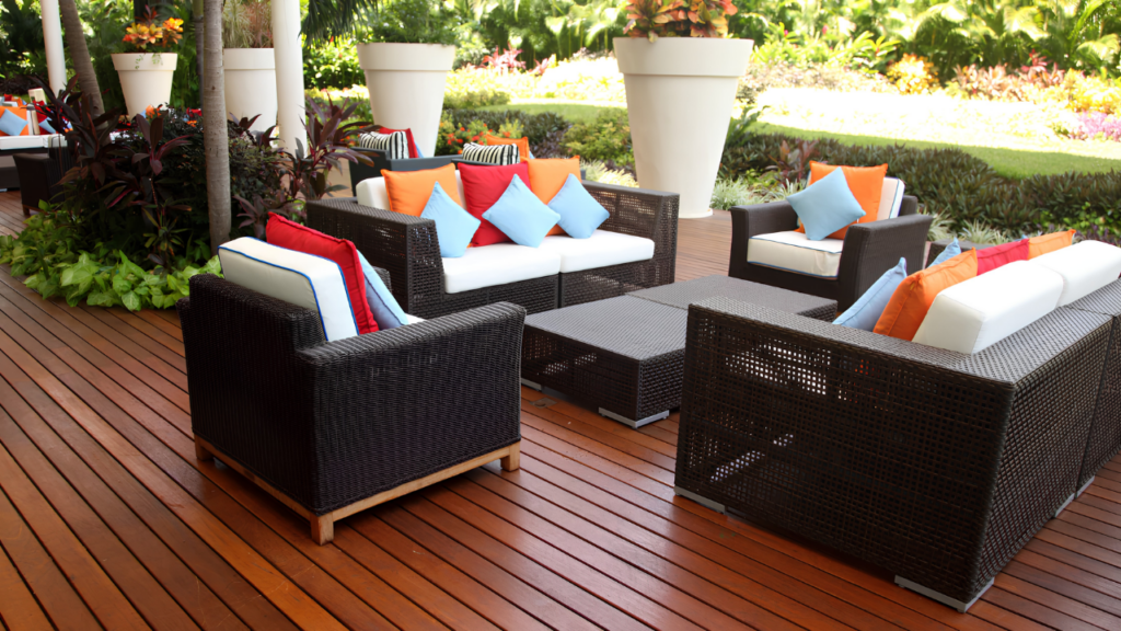 A stylish outdoor patio with modern patio furniture, including comfortable seating, a coffee table, and decorative accents in a landscaped backyard.