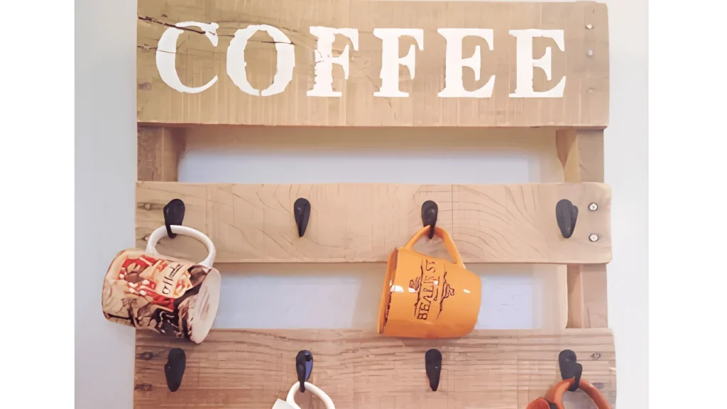 DIY pallet coffee cup holder made from reclaimed wood with black metal hooks