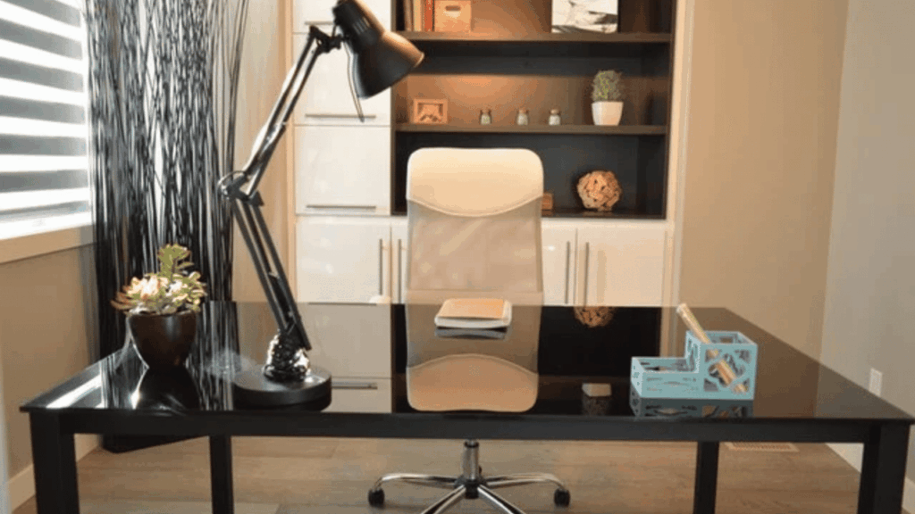 Modern home office setup with a desk, ergonomic chair, computer, and organized workspace.