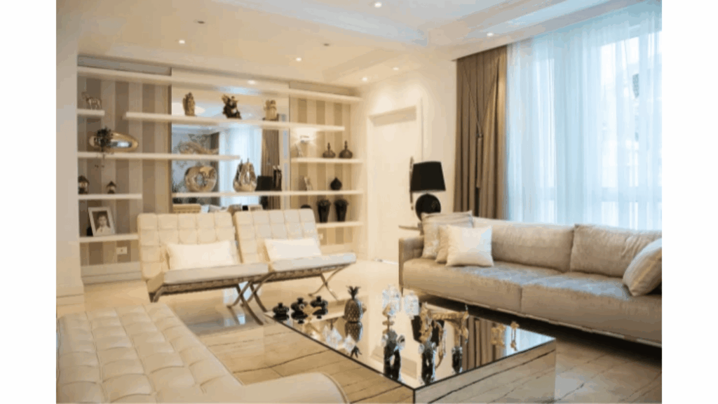 An elegant living room transformed with refined furniture, layered lighting, coordinated décor, quality textiles, and polished finishes that create a luxurious atmosphere.
