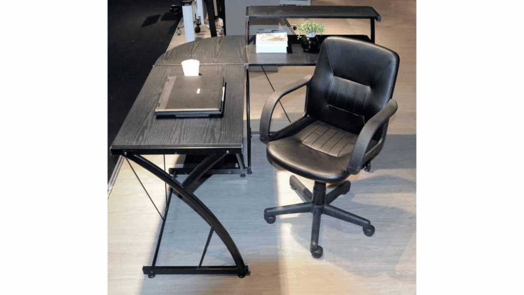 A compact office space efficiently arranged with a slim desk, ergonomic chair, vertical storage, organized accessories, and effective lighting.