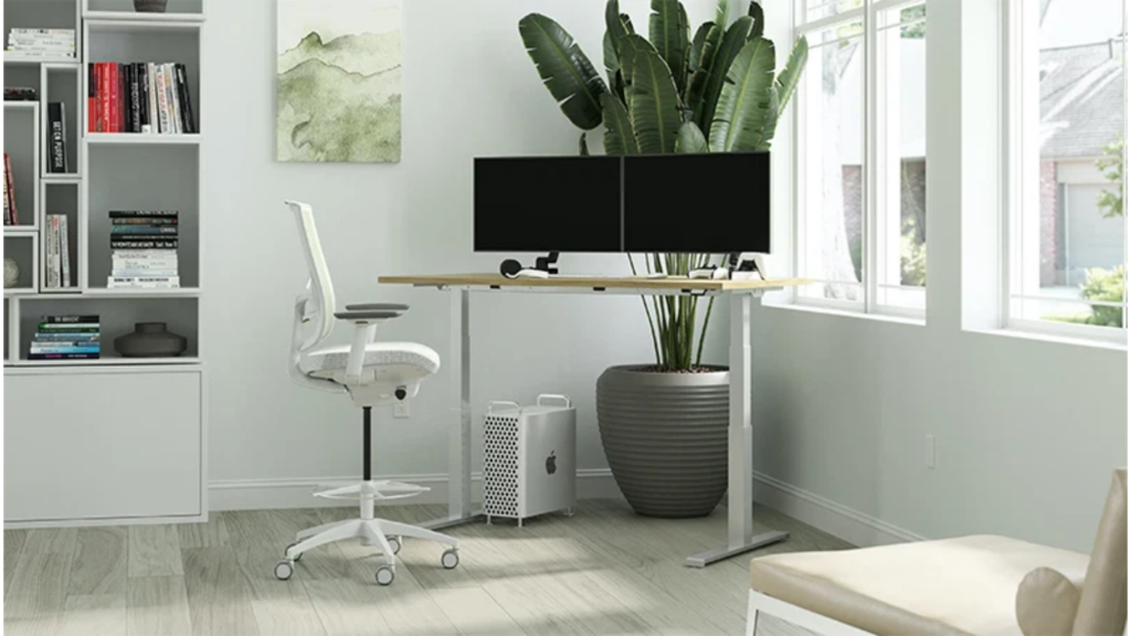 Ergonomic workspace setup featuring an adjustable office chair, properly positioned desk, monitor, keyboard, lighting, and organised accessories.